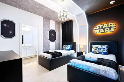 a bedroom with two beds and a star wars sign on the wall at Themed Kids' Rooms, Pool & Game Loft Near Disney in Kissimmee