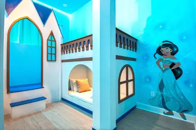 a childs bedroom with a mermaid mural at Themed Kids' Rooms, Pool & Game Loft Near Disney in Kissimmee