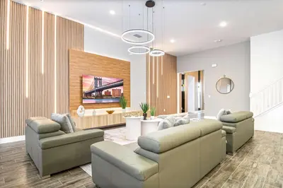 a living room with couches and a dining room at Themed Kids' Rooms, Pool & Game Loft Near Disney in Kissimmee