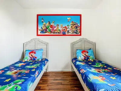 two twin beds in a room with twin beds at Windsor Hills Modern 3BR Condo with Resort Amenities in Orlando