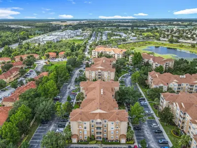 an aerial view of a building with a parking lot at Windsor Hills Modern 3BR Condo with Resort Amenities in Orlando