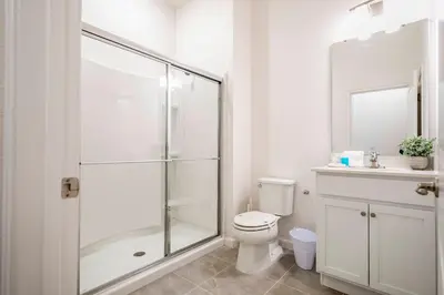 a bathroom with a shower and a toilet and a sink at Paradiso Grande 5 Bed New Townhome - 10329 in Orlando