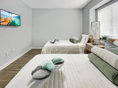 a white room with two beds and a couch at Rumi Haven-Homey&Spacious Stay in Orlando