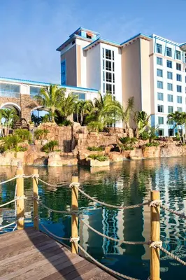 a resort with a pool of water in front of a building at Universal's Loews Sapphire Falls Resort in Orlando