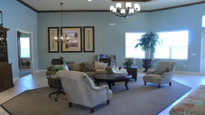 a living room with a couch and a table and chairs at SHVCK1 - Coral Cay Resort #1 - 4 Bedroom Townhouse in Kissimmee