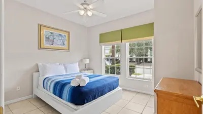 a bedroom with a bed and a ceiling fan at SHVCK3 - Coral Cay Resort #3 - 4 Bed 3 Baths Townhome in Kissimmee