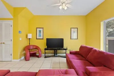 a living room with a couch and a tv at SHVCK3 - Coral Cay Resort #3 - 4 Bed 3 Baths Townhome in Kissimmee