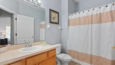 a bathroom with a sink and a toilet and a shower at SHVCK4 - Coral Cay Resort #4 - 4 Bed 3 Baths Townhome in Kissimmee