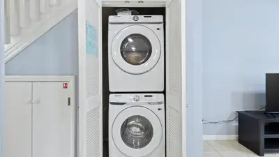 a washer and dryer in a room with a staircase at SHVCK4 - Coral Cay Resort #4 - 4 Bed 3 Baths Townhome in Kissimmee