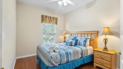 a bedroom with a bed with two towels on it at SHVCK5 - Coral Cay Resort #5 - 4 Bed 3 Baths Townhome in Kissimmee