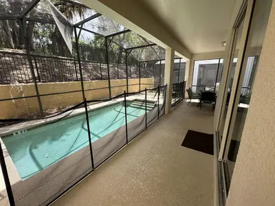 a swimming pool inside of a house with windows at SHVPP1 - Paradise Palms #1 - 6 Bed 5 Baths Villa in Kissimmee