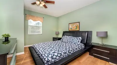 a bedroom with a bed and a ceiling fan at SHVCC1 - Crystal Cove #1 - 7 Bed 4.5 Baths Villa in Kissimmee
