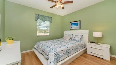 a bedroom with a bed and a ceiling fan at SHVCC2 - Crystal Cove #2 - 7 Bed 4.5 Baths Villa in Kissimmee