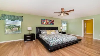 a bedroom with a bed and a ceiling fan at SHVCC2 - Crystal Cove #2 - 7 Bed 4.5 Baths Villa in Kissimmee