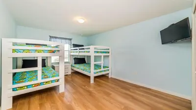 two bunk beds in a room with a flat screen tv at SHVCC2 - Crystal Cove #2 - 7 Bed 4.5 Baths Villa in Kissimmee