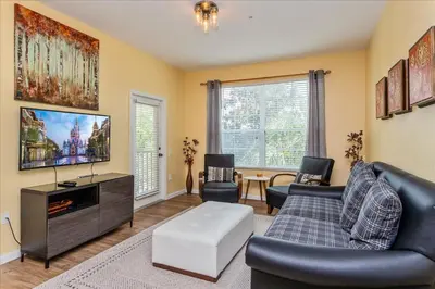 a living room with a couch and a tv at Peaceful Getaway in Windsor Hills in Orlando