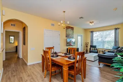 a dining room and living room with a table and chairs at Peaceful Getaway in Windsor Hills in Orlando