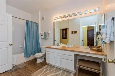 a bathroom with a sink and a toilet and a mirror at Peaceful Getaway in Windsor Hills in Orlando