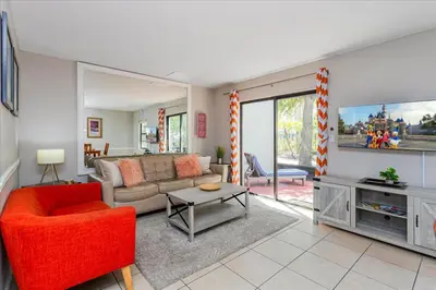 a living room with a couch and a tv at Cozy Townhome in Fantasy World Near Parks in Kissimmee