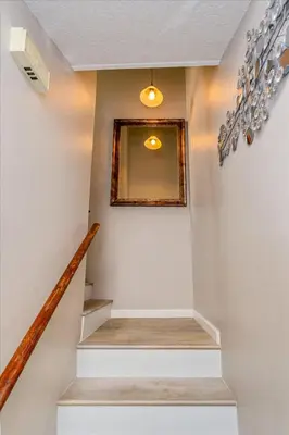 a staircase in a home with a picture on the wall at Cozy Townhome in Fantasy World Near Parks in Kissimmee