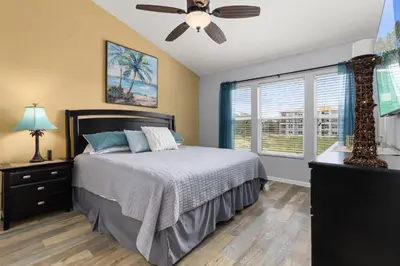 a bedroom with a bed and a ceiling fan at Cozy 3Br Villa With Pool Disney Nearby in Orlando
