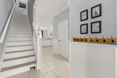 a staircase in a home with white walls at Cozy 3Br Villa With Pool Disney Nearby in Orlando