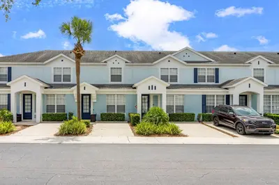 a house with a car parked in front of it at Cozy 3Br Villa With Pool Disney Nearby in Orlando