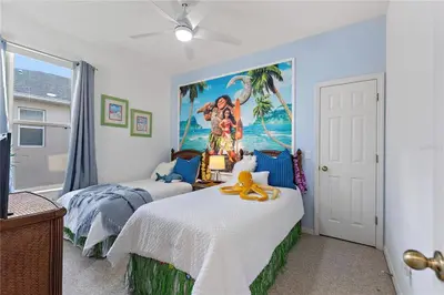 a bedroom with two beds and a painting on the wall at 4Br Pool Villa, Near Disney - Gated Resort! in Kissimmee