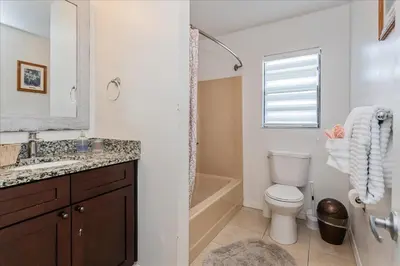 a bathroom with a toilet and a sink and a shower at Spacious Home in FantasyWorld in Kissimmee