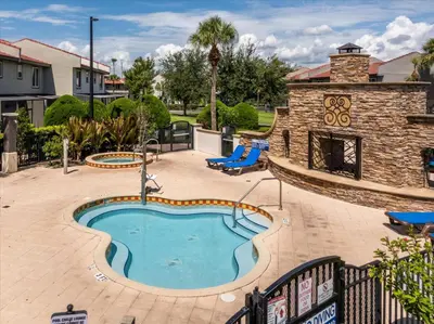 a patio with a swimming pool and a building at Spacious Home in FantasyWorld in Kissimmee