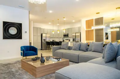 a living room with two couches and a dining room at Brand New 12 Bedrooms Single Family Paradiso 85HI in Orlando