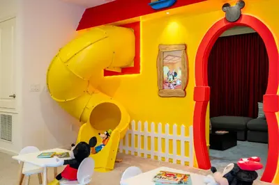 a childs room with a yellow and red play house at Brand New 12 Bedrooms Single Family Paradiso 85HI in Orlando