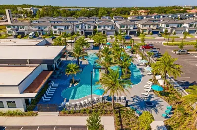 an aerial view of a resort with a pool and palm trees at Brand New 12 Bedrooms Single Family Paradiso 85HI in Orlando
