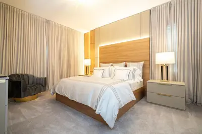 a hotel room with a bed and a chair at Brand New 12 Bedrooms Single Family Paradiso 85HI in Orlando