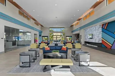 a lobby of a building with couches and chairs at Brand New 12 Bedrooms Single Family Paradiso 85HI in Orlando