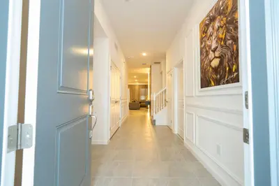 a hallway of a home with a painting on the wall at Brand New 12 Bedrooms Single Family Paradiso 85HI in Orlando