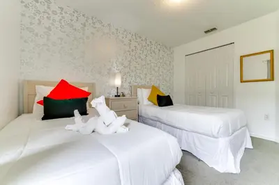 two white beds with stuffed animals on them in a room at 4 Mi to Disney Home with Pool Table, Outdoor Oasis! in Orlando