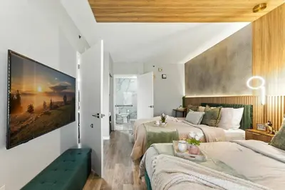 a bedroom with two beds and a large painting on the wall at 1 BR1 Bath sleeps 6 Close to Universal Parks in Orlando