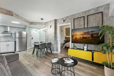 a living room with a yellow couch and a kitchen at 1 BR1 Bath sleeps 6 Close to Universal Parks in Orlando
