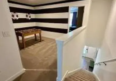 a hallway with a table and a bench in a room at 3231 ED - The Hub Modern 3BR in Kissimmee