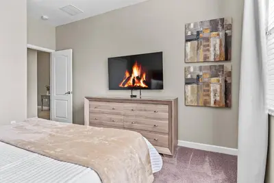 a bedroom with a bed and a fireplace on a dresser at Amazing 06 Bedrooms3 BathSleeps 14 in Kissimmee