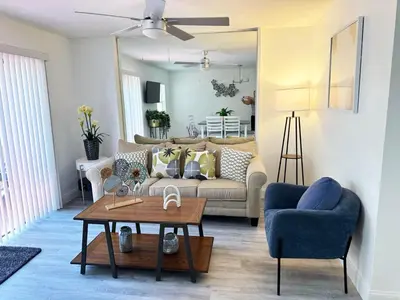 a living room with a couch and a table at Family vacation Villa in Fantasy World Resort - Minutes from Disney in Kissimmee