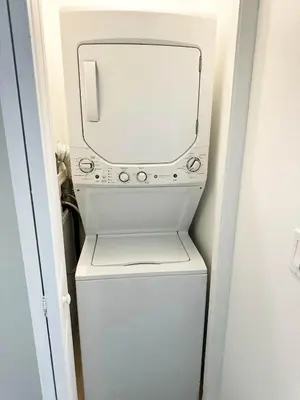 a white washer and dryer with a mirror on top at Family vacation Villa in Fantasy World Resort - Minutes from Disney in Kissimmee