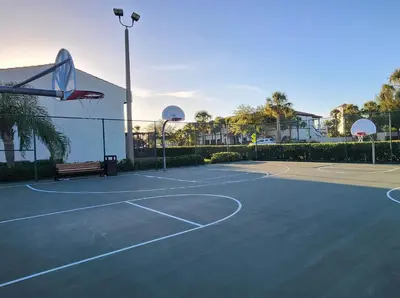 a tennis court with a bench and a basketball hoop at Family vacation Villa in Fantasy World Resort - Minutes from Disney in Kissimmee