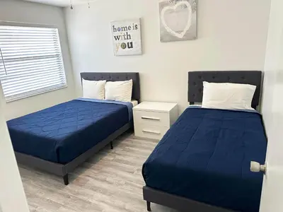two beds in a room with blue sheets at Family vacation Villa in Fantasy World Resort - Minutes from Disney in Kissimmee