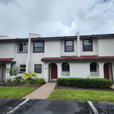 a white house with a red roof at Family Townhouse with Waterpark - Minutes from Disney in Kissimmee