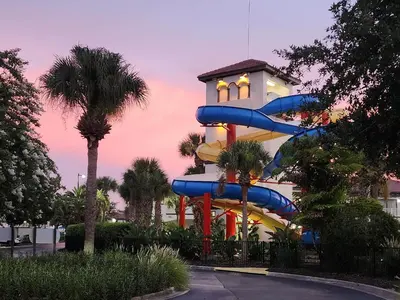 a water slide in front of a building at Family Townhouse with Waterpark - Minutes from Disney in Kissimmee