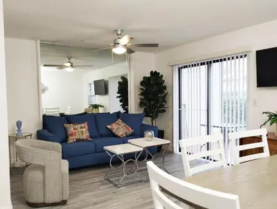 a living room with a blue couch and a table at Family Townhouse with Waterpark - Minutes from Disney in Kissimmee