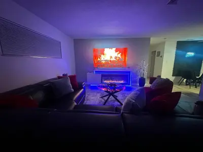 a living room with a couch and a fireplace at Historic Retreat on Eola + Private Hot Tub + Grill in Orlando