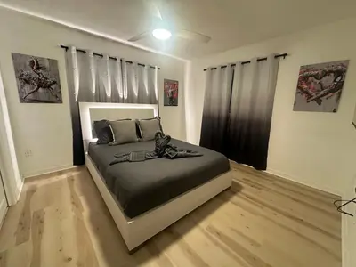 a bedroom with a large bed in a room at Eola Retreat Private Hot Tub with Grill in Orlando